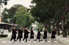 a group of people walking across a cross walk