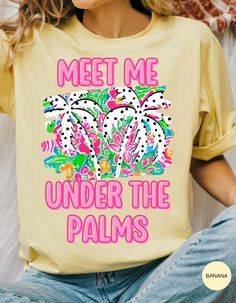 Escape to your tropical haven with our **Palms Paradise Rendezvous Tee**! This breezy, soft cotton shirt features the whimsical phrase "Meet Me Under the Palms," inviting you to daydream about sun-soaked beaches and swaying palm trees. Perfect for summer adventures, beach outings, or just adding a touch of paradise to your everyday style. Embrace the laid-back vibes and make every day a getaway with this must-have tee! Printed Yellow T-shirt For Vacation, Yellow Printed T-shirt For Vacation, Tropical Palm Tree Print Vacation Top, Tropical Palm Tree Print Tops For Beach Party, Tropical Palm Tree Print Tops For Vacation, Tropical Tops With Palm Tree Print For Beach Party, Spring Tropical T-shirt With Palm Tree Print, Palm Tree Print Top For Spring Beach Party, Spring Summer Tropical Print T-shirt