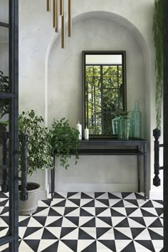 a black and white checkered floor with a mirror on the wall next to it