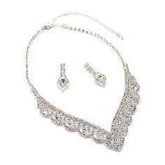 This bridal wedding jewelry set is simply stunning! This beautiful jewelry set is encrusted with clear, sparkling rhinestones in a sophisticated and elegant design. The necklace measures approximately 14" long with a 4" extender Chain for just the right fit. The matching Earrings measure approximately 1.5" long and 1.4g in weight. This set is perfect for brides, bridesmaids, pageants or any special event. This set coordinates with any color or style wedding dress or formal ensemble. Silver Bridal Sets With Diamond Accents, Silver Crystal Jewelry Sets With Diamond Accents, Silver Jewelry Sets With Diamond Accents And Crystal, Silver Jewelry Sets With Diamond Accents, Silver Bridal Set With Rhinestones And Cubic Zirconia, Silver Bridal Necklace With Bling, Silver Cubic Zirconia Bridal Necklace With Bling, Silver Jewelry Sets With Rhinestones And Cubic Zirconia, Silver Cubic Zirconia Jewelry Sets With Rhinestones