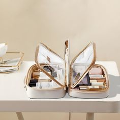 an open purse sitting on top of a white table