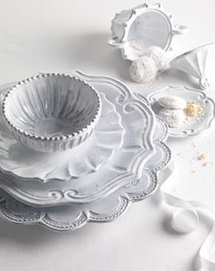 a white table topped with plates and bowls