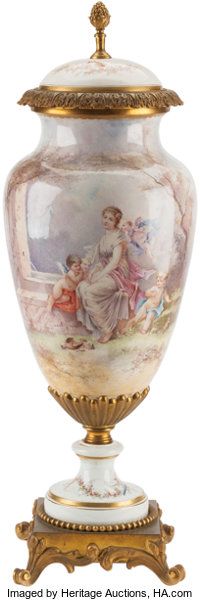 an ornate blue and gold urn with paintings on it