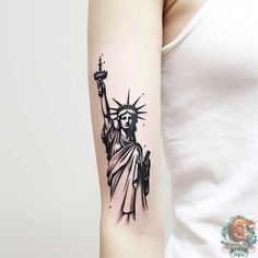 the statue of liberty tattoo on the right arm is shown in black and grey ink