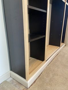 an empty shelf in the corner of a room next to a wall with shelves on it