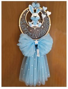 a blue dress hanging from the side of a wooden door with a clock on it