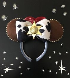 a minnie mouse ears headband with a star on it and stars in the background