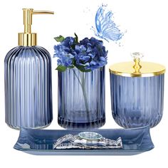 blue glass bathroom accessories including soap dispenser, toothbrush holder and vase