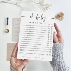 a person holding up a printable to do list with the words oh baby on it