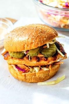 a chicken sandwich with pickles and onions