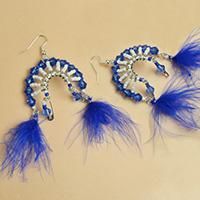 two pairs of earrings with blue feathers and beads