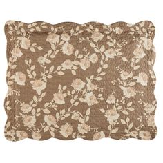 a brown and white pillow with flowers on it