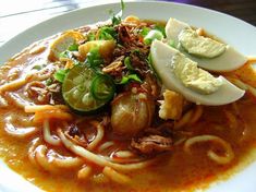 a white plate topped with noodles and vegetables