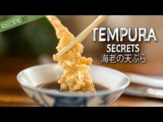 there is an advertisement for tempura secrets in the bowl with chopsticks sticking out of it