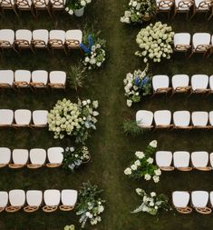 an overhead view of rows of chairs with white flowers and greenery at the back