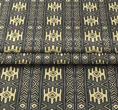 a black and yellow patterned fabric with gold accents