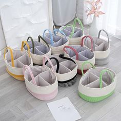 several baskets with handles are lined up on the floor