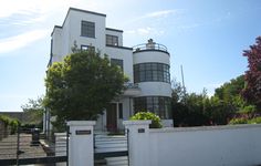 a large white house sitting on the side of a road