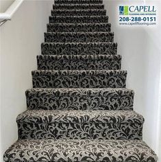 the carpeted stairs are decorated with black and white designs