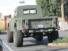 an army truck is parked in a parking lot