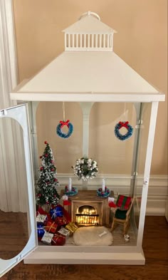 a doll house with a fireplace and christmas decorations