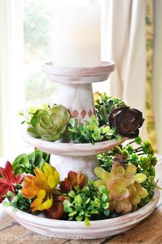 three tiered tray with succulents and a candle