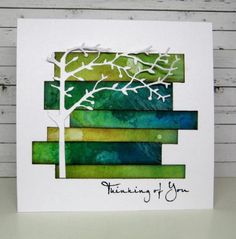 a card with the words thinking of you written on it and a tree in the middle