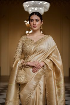 a woman in a gold sari