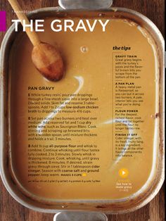 the gravy is in a metal pan with a wooden spoon on top of it