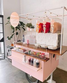 an ice cream cart is set up in front of a window