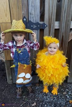 two children dressed up in costumes standing next to each other