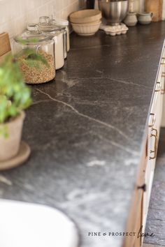 a kitchen counter with pots and pans on it