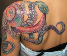 an octopus tattoo on the back of a woman's upper half - arm and shoulder