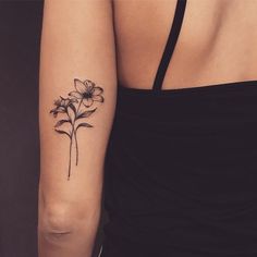 a woman with a flower tattoo on her arm