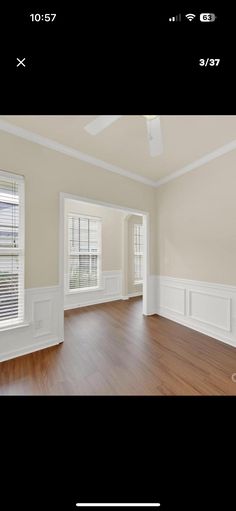 an empty living room with hard wood floors and white trim on the walls is shown