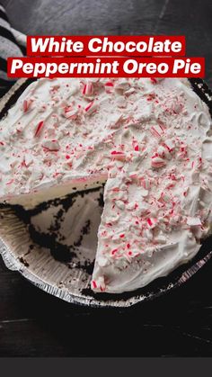 a cake with white frosting and red sprinkles