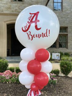 a balloon with the letter a on it and some red and white balloons attached to it