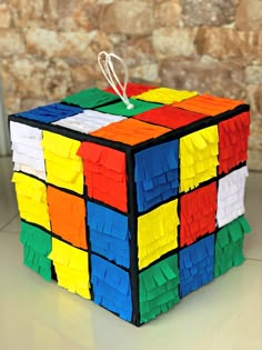 a rubik cube made out of colored paper