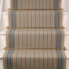 a carpeted stair case with blue and yellow stripes