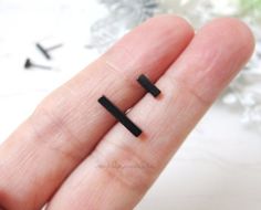 * Black Stainless steel Bar stud earrings.  Minimalist jewelry for men and women.* This price is for one pair ( 2 pieces )* These earrings are made of stainless steel, nickel free plating.  They come with stainless butterfly earring backs.* Dimensions :  Choose from 6mm -or- 12mm      Bar length :  10 mm **Measurements are an approximation. Size, shape and color can vary slightly from above dimensions.**♥♥ For 9mm BLACK Bar earrings, please visit this link   https://www.etsy.com/listing/71225183 Modern Black Piercings For Gift, Modern Black Piercings As Gift, Minimalist Black Hypoallergenic Piercings, Black Hypoallergenic Minimalist Piercings, Minimalist Black Internally Threaded Cartilage Earrings, Minimalist Black Nickel-free Piercings, Black Nickel-free Minimalist Piercings, Black Minimalist Cartilage Earrings For Everyday, Minimalist Black Single Plug Earring