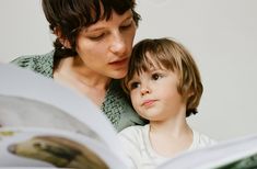 a woman reading a book to a child