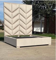 a bed that is sitting in the middle of some concrete blocks with an interesting design on it