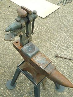 an old metal object sitting on top of a table