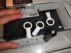 someone is measuring the size of their scissors and tape measures them to make sure that they are not in use