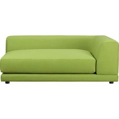 a green couch sitting on top of a white floor