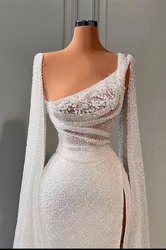 a white dress with long sleeves on display