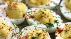 deviled eggs are topped with chives and seasoning