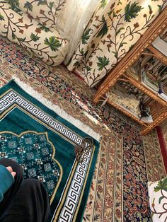 a person sitting on the floor in front of a rug