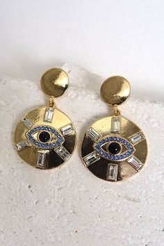 Evil Eye Pendant Earrings.Keep the bad vibes away with this evil eye rhinestone earring featuring high polish plating and post backing. Length: 1.5" Metal Dangle Earrings With Evil Eye, Party Dangle Evil Eye Jewelry, Evil Eye Metal Jewelry For Parties, Metal Evil Eye Jewelry For Parties, Bad Vibes, Eye Pendant, Evil Eye Pendant, Rhinestone Earrings, The Bad