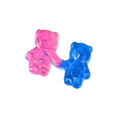 two gummy bears sitting next to each other on a white surface with blue and pink colors